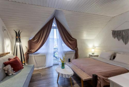 a bedroom with a bed and a large window at Захарова Оселя БАСЕЙН на території є Чан - Джакузі in Slavske