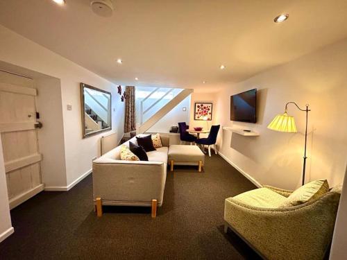 a living room with a couch and chairs at The Barn in Cam