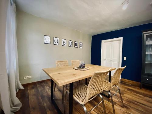 a dining room with a wooden table and chairs at # One Apartment's / Parkplatz / Schlossplatz in Coburg