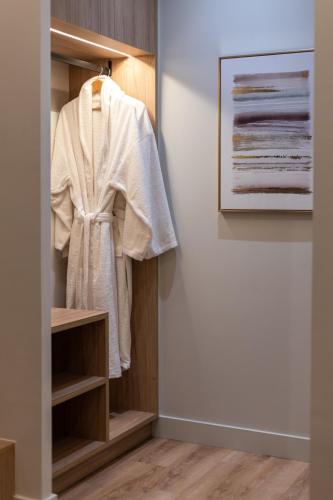 a closet with a white robe hanging in it at Philia Boutique Hotel in Athens