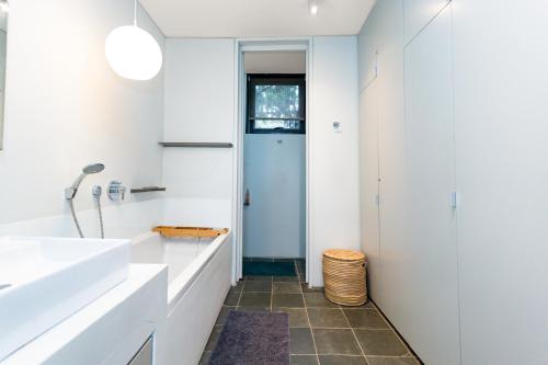 a bathroom with white walls and a blue door at 9 Dash Apartment, Dunkirk Estate in uMhlali