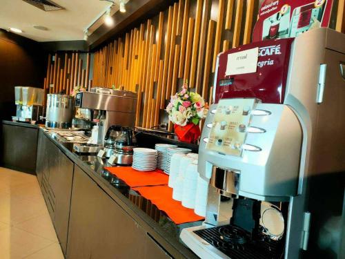 a kitchen with a counter with a coffee machine at Wangchan Riverview in Phitsanulok