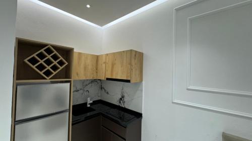 a kitchen with a refrigerator and a ceiling at Apartments Costa Azzurra in Velipojë