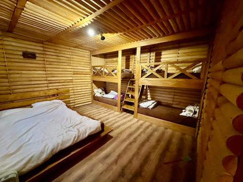 a room with a bed and two bunk beds at Etno Selo Krnić in Vladimirci