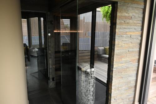 a glass door leading into a living room at SUBSTANTIEL - Luxury Rooms & Wellness Suite in Brunehaut