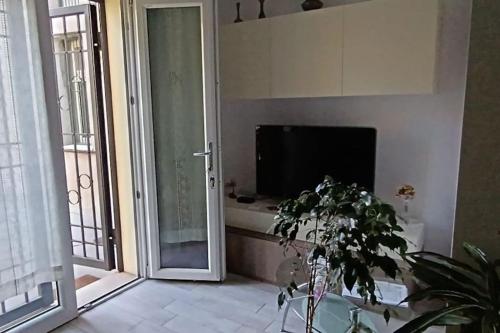 a bathroom with a tub and a tv in a room at Villa Maria in Marina di Ravenna