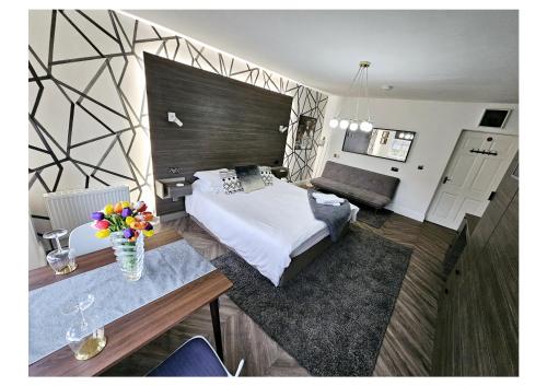 a bedroom with a bed and a table with flowers on it at Home Sweet Home in Ballycastle