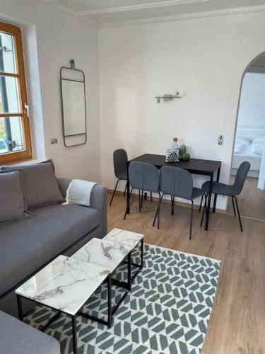 a living room with a couch and a table with chairs at Apartment in Velden am Wörthersee, Top 3 in Velden am Wörthersee