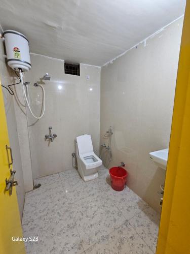 a bathroom with a toilet and a sink at The Ortus Stays -The Sunset Room in Orchha