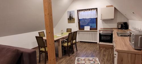 a kitchen with a table and chairs in a room at Ferienhof Fischer in Seebach