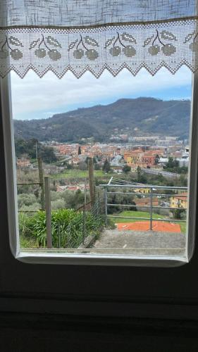 a window with a view of a city at IL SOLE DI AURORA in Carasco
