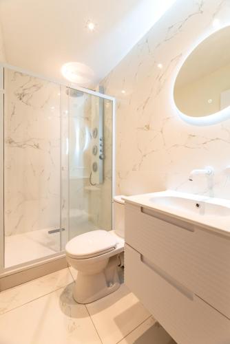 a bathroom with a shower and a toilet and a sink at Studios Le Médicis in Rouen