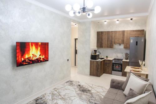 a living room with a fireplace on the wall at Astana arena ЖК Бухар Жырау in Taldykolʼ