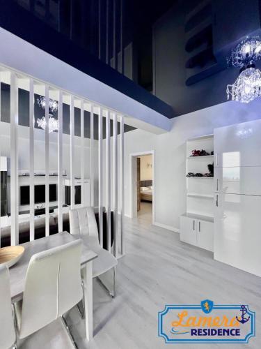 a dining room with white furniture and a blue ceiling at Lamera Residence Mamaia - Apartamente cu 1-2-3 camere cu acces si vedere la lac in Mamaia