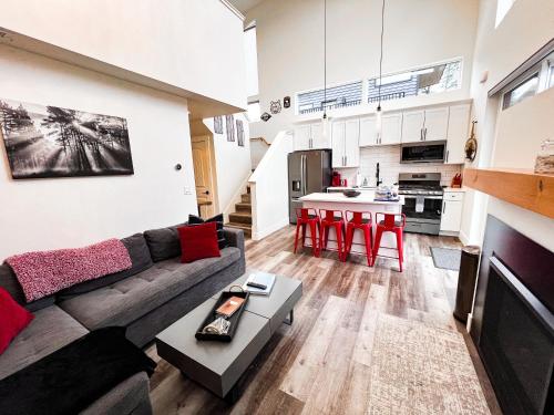 a living room with a couch and a kitchen at Red Poppy at the Quarry in Whitefish
