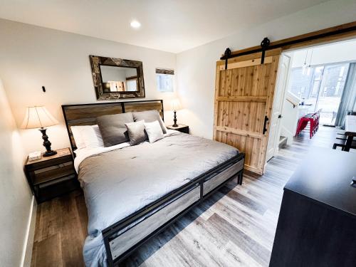 a bedroom with a bed and a mirror on the wall at Red Poppy at the Quarry in Whitefish