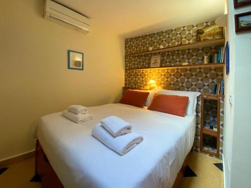 a bedroom with a white bed with towels on it at Le Petit Prince in Rome