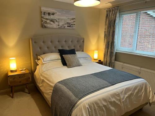 a bedroom with a large bed and a window at Tarporley No 7 in Tarporley