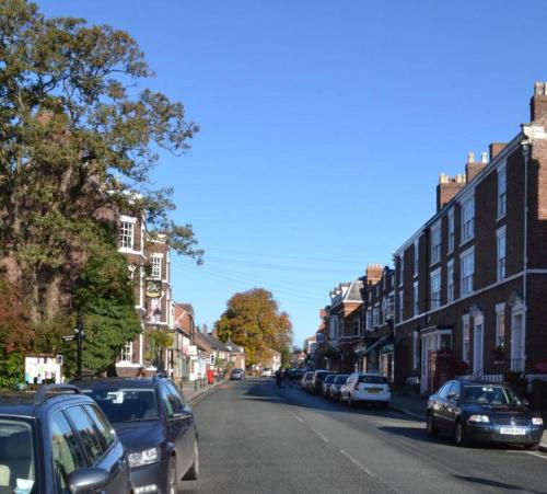 a city street with cars parked on the side of the road at Tarporley No 7 in Tarporley