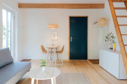 una sala de estar con una puerta azul y una mesa en Rückzugsort mitten im Paradies en Feldafing