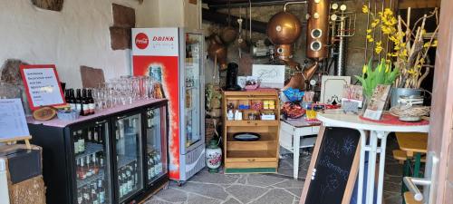 a shop with a lot of bottles of wine at Ferienhof Fischer in Seebach