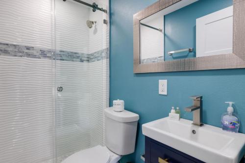 a bathroom with a shower and a toilet and a sink at Pirates Retreat Cottage at Palmview Inn of Sanibel in Sanibel