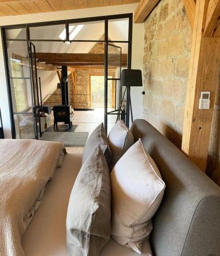 a couch with pillows on it in a living room at Pension Pallini in Geiselwind