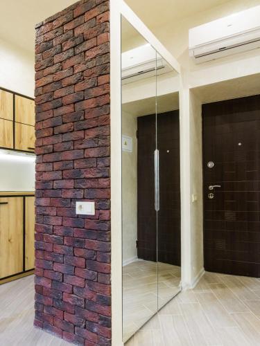 a brick wall in a room with a glass door at CityApartments Kyiv Maidan in Kyiv