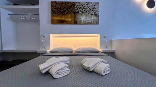 MykonosCasa في مدينة ميكونوس: غرفة نوم عليها سرير وفوط