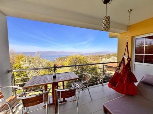 a balcony with a table and chairs and a view at Villa Velestovo in Ohrid