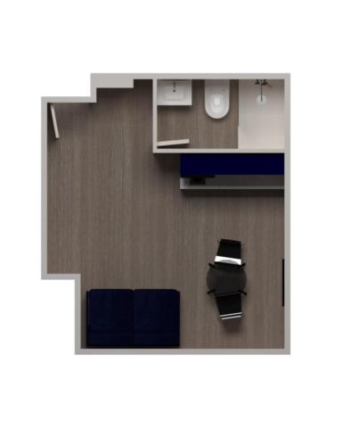 a room with two blue chairs and a counter at Studios Le Médicis in Rouen