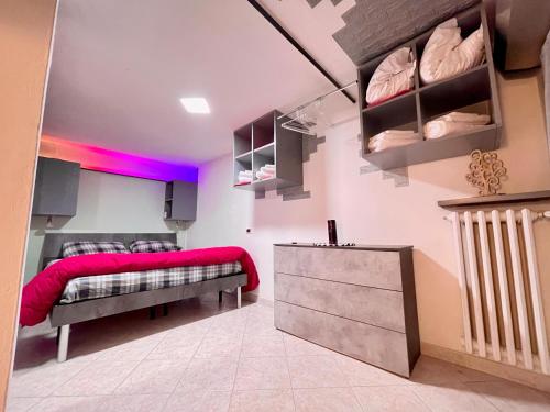 a bedroom with two beds and pink lighting at bilocale 40 mt dal mare 2 piani in Rimini