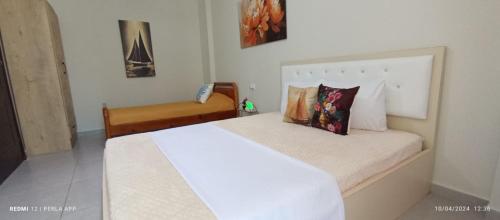 a bedroom with a large white bed with pillows at Perla Apartment 3 in Golem