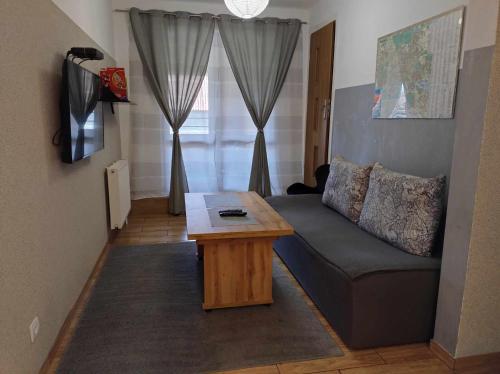 a living room with a couch and a coffee table at Apartament Gospodarska in Białystok