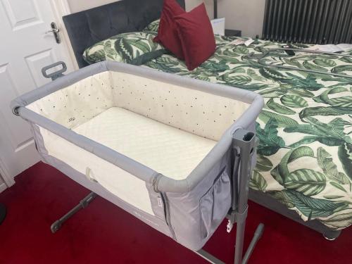 a hospital bed in a room next to a bed at Stylish Home Away From Home in Kent with Easy Access to London! in Wrotham