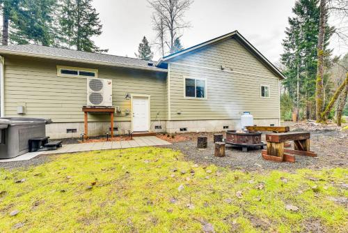 a backyard with a house and a grill at Family-Friendly Packwood Retreat with Deck! in Packwood
