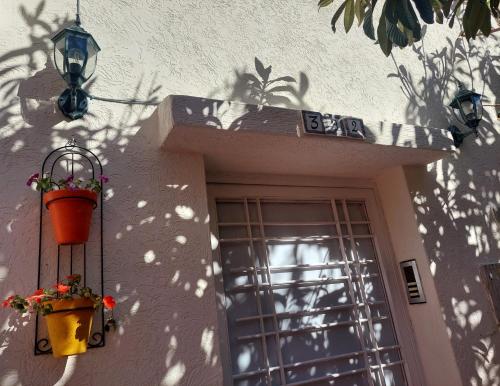a building with two flower pots and a window at Chabili Appartements in Temara