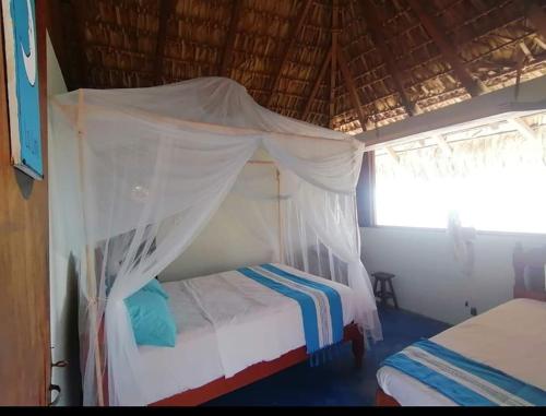Postel nebo postele na pokoji v ubytování Cabañas Paraiso Chacahua