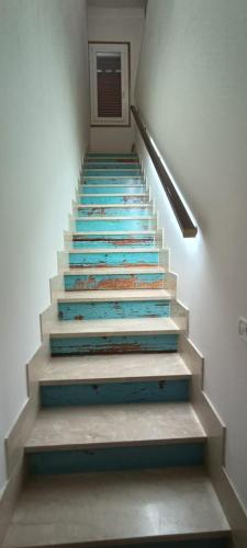 a staircase with colorful tiles on the stairs at SE LO SENTI LO SAI in Triscina