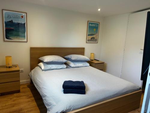 a bedroom with a bed with a blue towel on it at Logement avec piscine privée chauffée in Biarritz