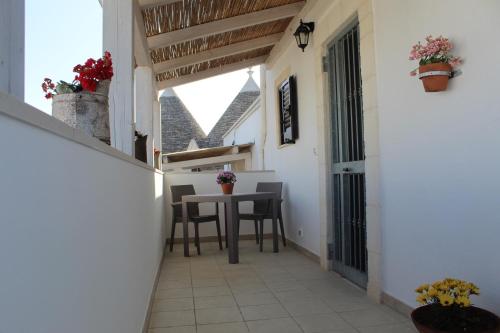 a corridor of a house with a table and chairs at Trulli Nonna Grazia -miramonti in Cisternino