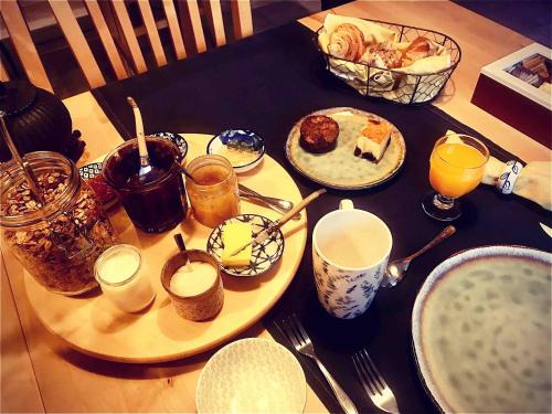 a table topped with plates of food and drinks at Gîte An Daou Tok in Mellionnec
