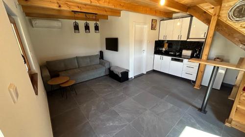 a living room with a couch and a kitchen at Villa LANA Krupa na Vrbasu in Banja Luka