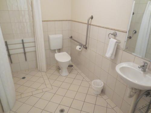 a bathroom with a toilet and a sink at Holdfast Shores Apartments in Adelaide