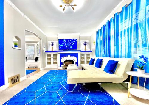 a living room with a white couch and blue carpet at The Sapphire Haven - Your Old Brooklyn Oasis Awaits Families, Couples, Business Travelers Near Downtown With Parking, 300 MB WiFi & Self Check-In in Cleveland
