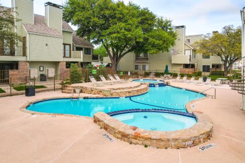 a swimming pool with lounge chairs in a resort at 3 Mi to Dtwn Fort Worth! Condo with Hot Tub and Pool in Fort Worth