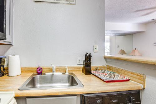 a kitchen with a sink and a counter at Cozy Fort Worth Condo Close to Downtown! in Fort Worth