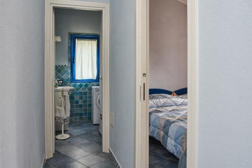 a bedroom with a bed and a bathroom with a toilet at Casa Azzurra in Cala Gonone