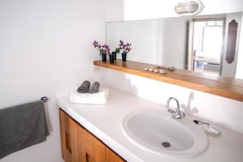 a bathroom with a sink and a mirror at The Red Winehouse in Foinikiá