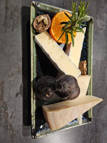 a tray of cheese and vegetables on a table at Millésime in Perville